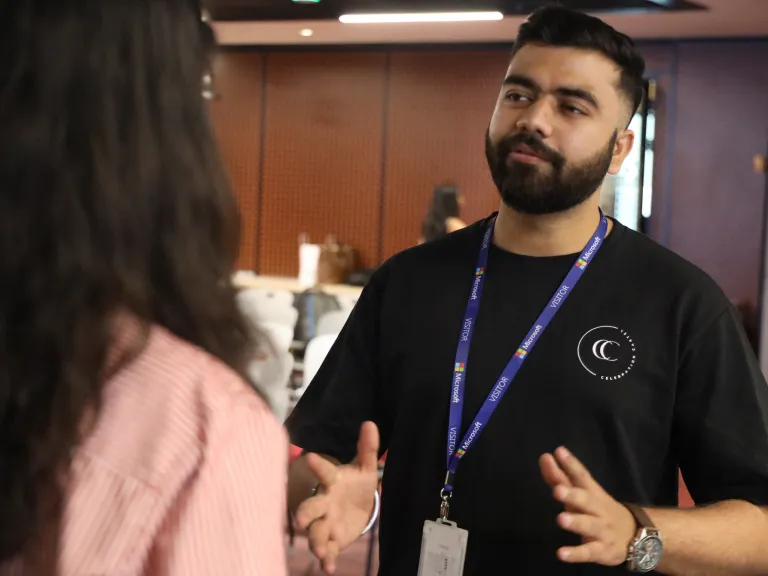 A facilitator supporting a hackathon participant